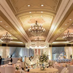 This wide-angle view showcases a grand carousel-themed birthday party we planned at the Taj Palace, New Delhi. The entire ballroom was transformed with luxurious draping, multiple crystal chandeliers, and a magnificent central carousel, demonstrating our ability to execute large-scale, luxury events.