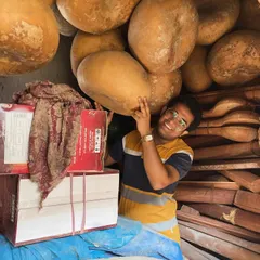 In the warehouse, surrounded by dried gourds (tumbas) that will become the resonant bodies of future sitars. It is fascinating to see the raw materials of our craft.