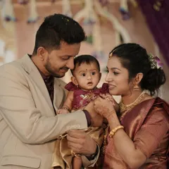 A heartwarming family photo from a cradle ceremony. The soft, elegant floral backdrop provides a beautiful setting for this precious family moment.