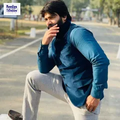 A simple and smart look for any occasion. This client is wearing a solid blue Nehru jacket over a formal shirt, a great example of versatile semi-formal wear that we tailor at your doorstep.