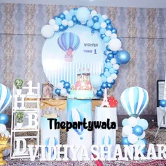 A sweet Hot Air Balloon theme for a first birthday, with a large backdrop and themed pedestals.