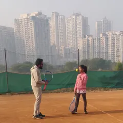 A close up of a coaching moment with Kavya. We are working on keeping the ball in front and maintaining balance through the shot, crucial elements for consistent groundstrokes.