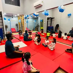A moment of focus during one of our kids' fitness sessions. Here, children are seated on safety mats as they listen to instructions, a key part of our classes that helps develop discipline and listening skills alongside physical activity.