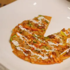 Bite-sized heaven. This is my Chipotle Mexican Pizza, a crispy tortilla base topped with beans, cheese, and a smoky sauce.