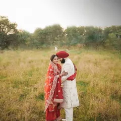 A romantic outdoor portrait of the couple in their wedding attire. The natural setting provides a beautiful, soft backdrop for this intimate moment.