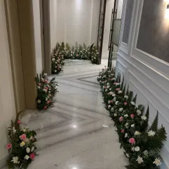 A beautiful floral runner decorating the hallway for a home wedding function. This simple touch adds elegance and a celebratory feel to the space.