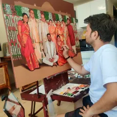 Here you can see the artist adding the final, detailed touches to a large family group portrait. Every person is painted with care to capture their unique likeness and personality.