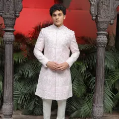 An ensemble of class and royalty, handmade to perfection. This light pink embroidered sherwani offers a soft yet regal look for the modern groom who wants something a bit hatke.