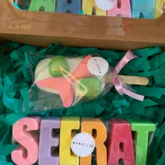 A beautiful mermaid-themed gift box featuring pastel rainbow name soaps for 'Arhaan' and 'Seerat'. Paired with a detailed mermaid popsicle soap, it's a magical and personal present.