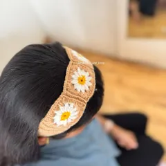 Here is another view of the crochet daisy headband being worn. It sits comfortably on the head and adds a really sweet, handmade touch.