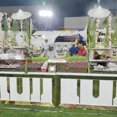 A farm-themed salad buffet counter with wheatgrass planters and traditional Indian farmer hats, showcasing my creative approach to event catering.
