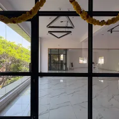 The view from the outside looking in. Our studio is designed with large glass windows to be a bright, open, and inviting space for everyone who walks through the door.