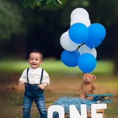 A big, happy smile from the birthday boy during his outdoor first birthday session.