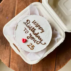 A classic and simple birthday bento cake. The white frosting provides a clean canvas for the "Happy Birthday to you" message, with the age "25" and a single red heart.