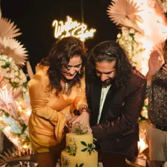 A happy couple cutting into their two-tiered Maska wedding cake. We feel so much joy being a part of these special moments, providing a delicious centerpiece for your celebration.