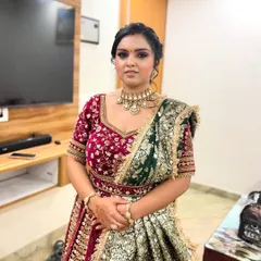 A full view of the bridal ensemble, showing how the makeup harmonizes with the intricate jewelry and dual-toned lehenga. The focus is on a balanced look that is elegant and regal.