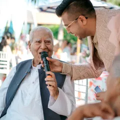 Interacting with guests of all ages is what I do best. This heartwarming moment with an elder at a destination wedding in Thailand is a perfect example of how I connect with everyone.