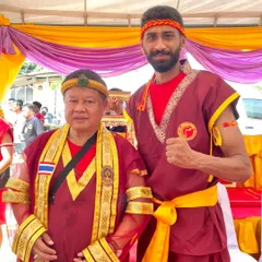 With my master, Grand Master Woody, during a traditional ceremony. I am honored to learn from and stand by a legend of Muay Thai.