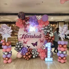 I created this enchanting butterfly and fairy theme for a first birthday party. The decor features a custom backdrop, character cutouts on balloon pillars, and a mix of chrome and pastel balloons.