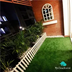 I transformed this small balcony into a charming cottage-style garden for the evening. The combination of soft artificial grass, a classic white picket fence, and a decorative window mirror against the brick wall creates a whimsical and cozy atmosphere, perfect for unwinding after a long day.