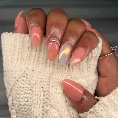 A close-up of the peach set, highlighting the shiny chrome accent nail and the perfectly placed silver chain. It's all in the details.