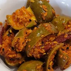 A bowl of my traditional Punjabi mango pickle. This is a classic recipe with whole spices and dried red chilies, giving it a rich and authentic taste. It is made without any preservatives, just like at home.