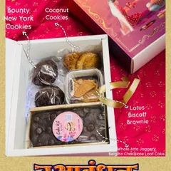 An assorted goodies hamper I designed for Raksha Bandhan. It features a whole atta jaggery loaf cake, a Lotus Biscoff brownie, and both Bounty and coconut cookies, all in a festive box.