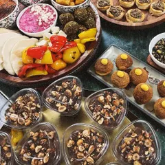 Here’s a little preview of how I can make your hosting duties easy and delicious. This spread features a mix of my Mediterranean appetizers, bite-sized desserts, and savory snacks, all made from scratch for your party.