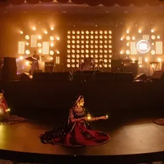 Dancers perform a piece with traditional diyas, adding a beautiful, serene element to the live show. We choreograph these moments to create visual highlights that punctuate the musical performances.