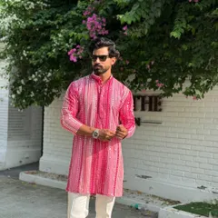 The vibrant pink and white stripes of this modern kurta create a visually appealing pattern. It's a versatile piece that can be dressed up or down for various festive occasions.