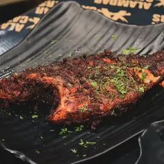 A whole fried fish, marinated in our special blend of spices and cooked to perfection. It's crispy on the outside and tender on the inside.