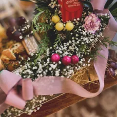 A close-up of the thoughtful indulgence in the charcuterie hamper, showing the interplay of food, florals, and playful details.