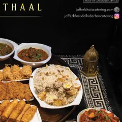 A closer look at the components of our Thaal, including biryani, fried starters, spring rolls, and rich curries, all arranged beautifully on a traditional mat.
