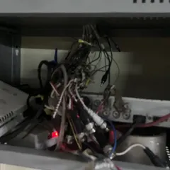 This is what we often find: a tangled mess of wires behind a DVR. This kind of setup is a fire hazard and the main reason for system failures, blurry footage, and recording gaps.