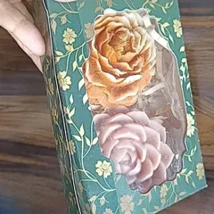 This decorative floral box is being used to package two large rose-shaped soaps or candles. It's a beautiful and sturdy option for gifting.
