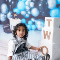 Posing with the "TWO" blocks, this little dude is proudly celebrating his second birthday in style.