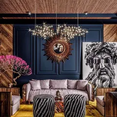We draw inspiration from bold, maximalist designs that layer color, texture, and art. This image reflects our love for creating dramatic spaces with statement pieces like a sunburst mirror, a modern art canvas, and a striking chandelier against a dark, paneled wall.