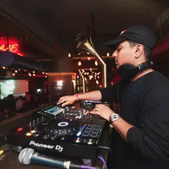 Total focus. During a set, I'm locked into the music and the flow of the party. This is me fine-tuning the mix on the Pioneer DJ console, making sure every transition is perfect and the energy on the dancefloor keeps building.