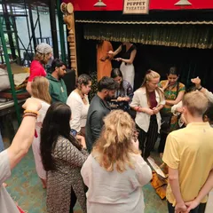 A moment of discovery during an experiential puppet play session. After the show, we invite our guests to get a closer look and even try their hand at manipulating the puppets, creating a memorable, hands-on cultural experience.