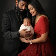 A complete picture of love. This classic family portrait against a dark, elegant backdrop brings all the focus to the three of you and the beautiful new life you've created together.