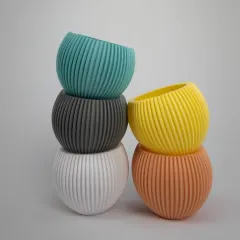 Our collection of colorful, textured pots is perfect for adding a pop of personality to your plant collection. These ribbed, spherical planters come in a variety of modern colors to match any decor.