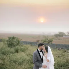 A tender kiss against a soft, golden sunset. This image showcases our ability to capture romantic, gentle moments during a Christian wedding ceremony, using natural light to create a dreamy atmosphere.