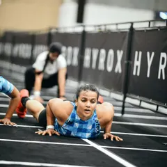 Pushing through fatigue with burpee broad jumps at Hyrox. These workouts build mental toughness just as much as physical strength.