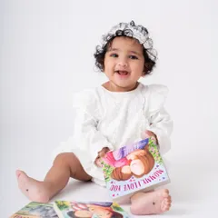 We can incorporate your baby's favorite books and toys into the session. It makes them feel comfortable and helps capture their personality. This little bookworm is ready for story time.
