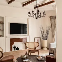 AD highlighted the living room's restored fireplace and custom TV unit, framed by classic wall molding. This detail shot shows how I integrate modern necessities like televisions into a space without sacrificing its traditional charm.
