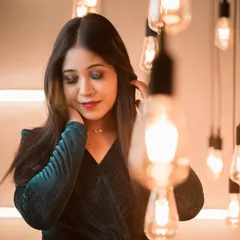 A softer, more candid shot of the smokey cocktail makeup. This shows how the look appears in warm, ambient lighting, highlighting the shimmer on the eyelids and the smooth skin finish.