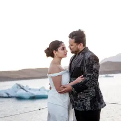 An ethereal, angelic vibe was the goal for this look. We chose a serene white Gaurav Gupta gown that flowed effortlessly against the icy backdrop, with a playful printed blazer for the groom to share the spotlight.