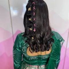 Getting creative with braids and accessories. This unique hairstyle features a delicate lace-like braid woven with pink thread and accented with gold clips for a modern and trendy look.