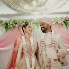 The newly married couple sharing their first look after the rituals, standing under a magnificent chandelier.