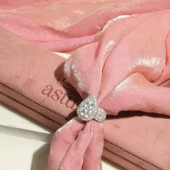 A creative shot of the Raiya Cocktail Ring. Even when not worn, its impressive scale and the sheer brilliance of the 7 carat diamond cluster make it a work of art.